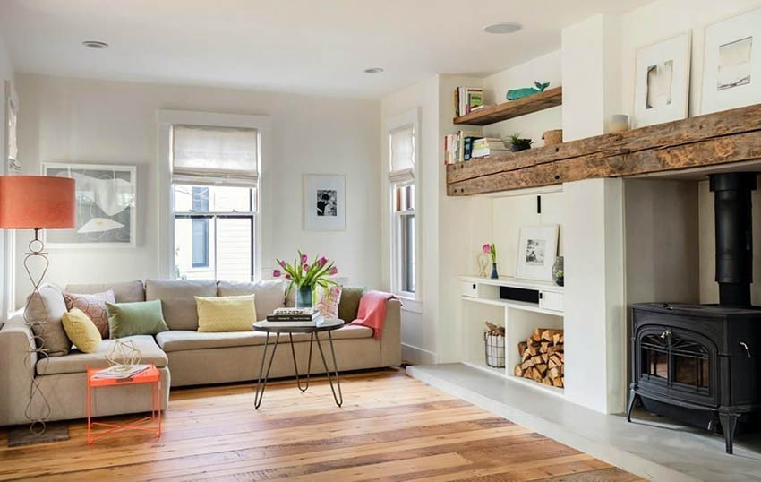 Living room with rough hewn planks above wood burning fireplace