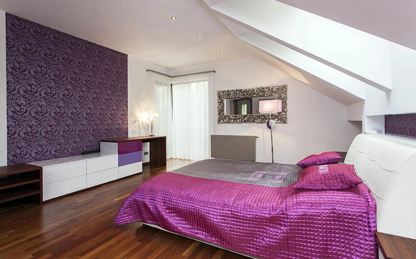 Loft bedroom with purple wallpaper accent wall and skylights