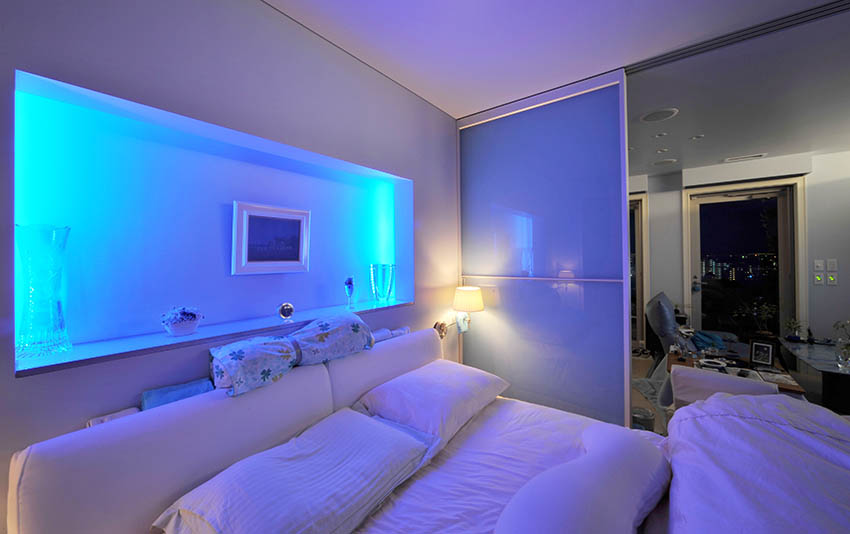 Modern bedroom with recessed accent wall with neon lighting