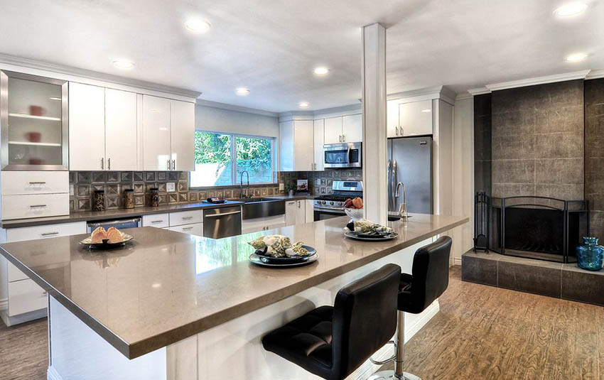 Modern kitchen with cork plank floors and white cabinets