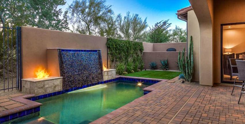 Lap pool with tiled wall and pavers