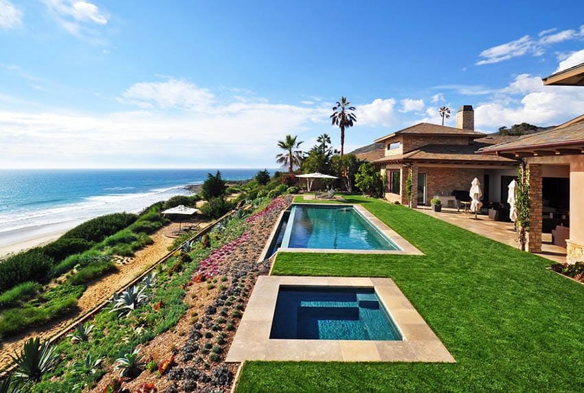 Oceanfront pool with stone tile and expansive lawn