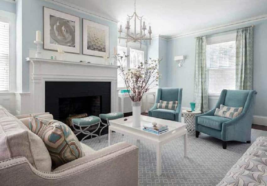 Powder blue living room with white wainscoting fireplace and chandelier