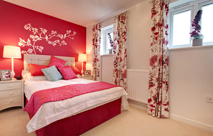 Red and grey bedroom with flower stencil behind bed