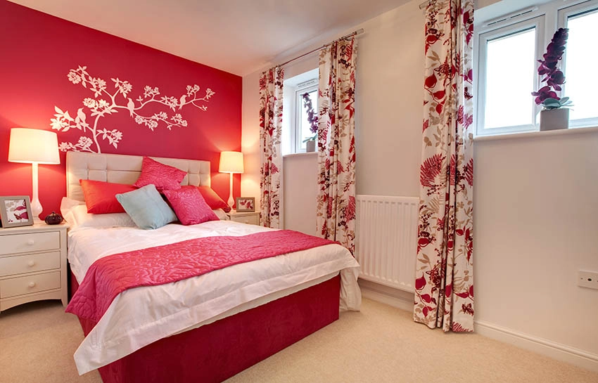 Red and grey bedroom with flower stencil accent wall behind bed