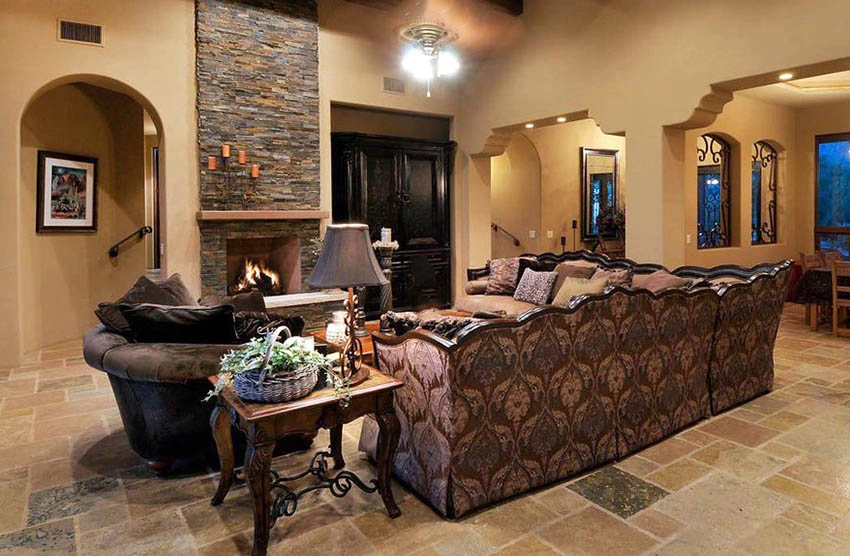 Rustic living room with stacked stone fireplace and travertine flooring