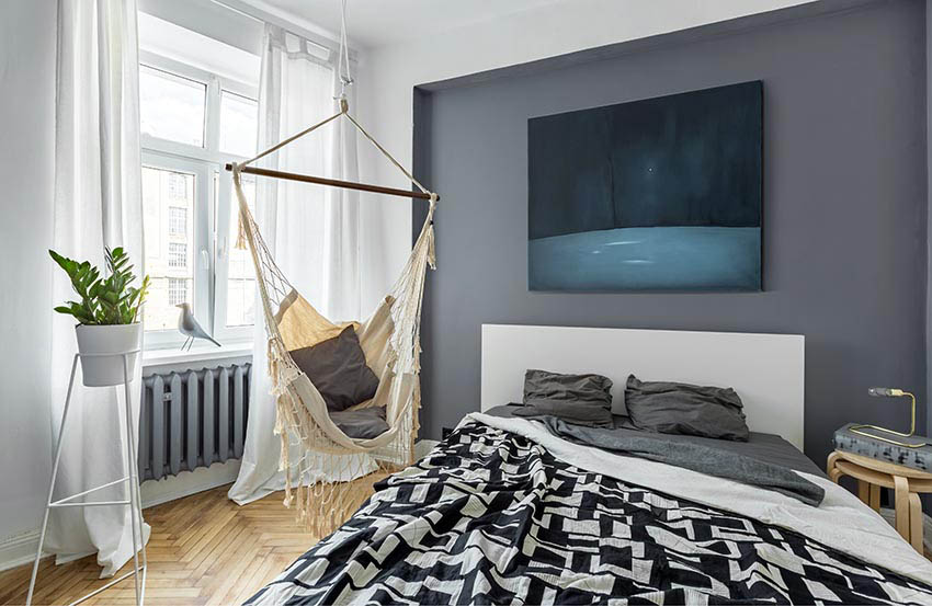 Teens bedroom with hanging chair and white paint with gray wall