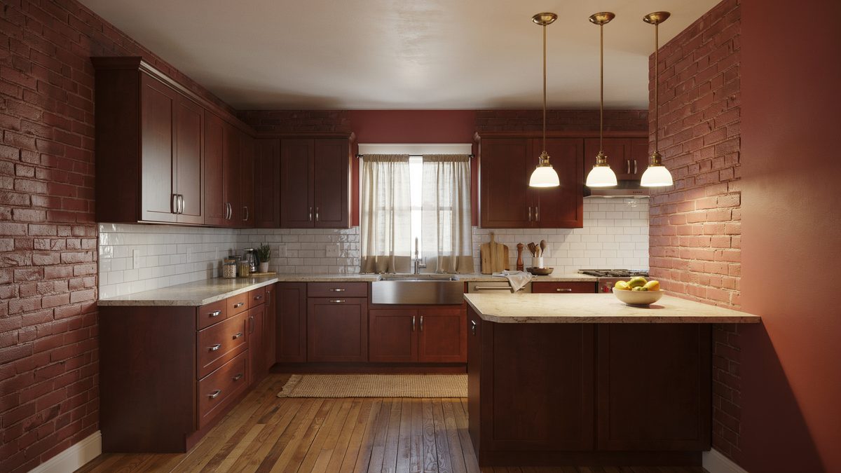 Dark cherry cabinets against brick red walls with three glass pendant lights