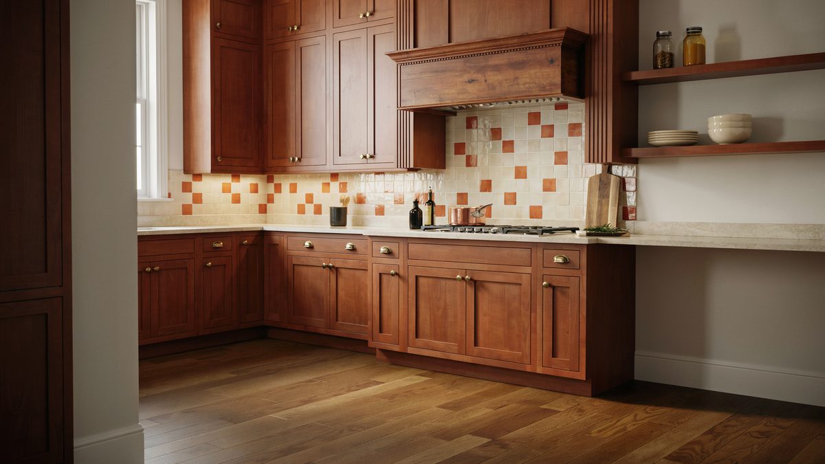 Cherry cabinets with tall wood range hood and orange square tile backsplash
