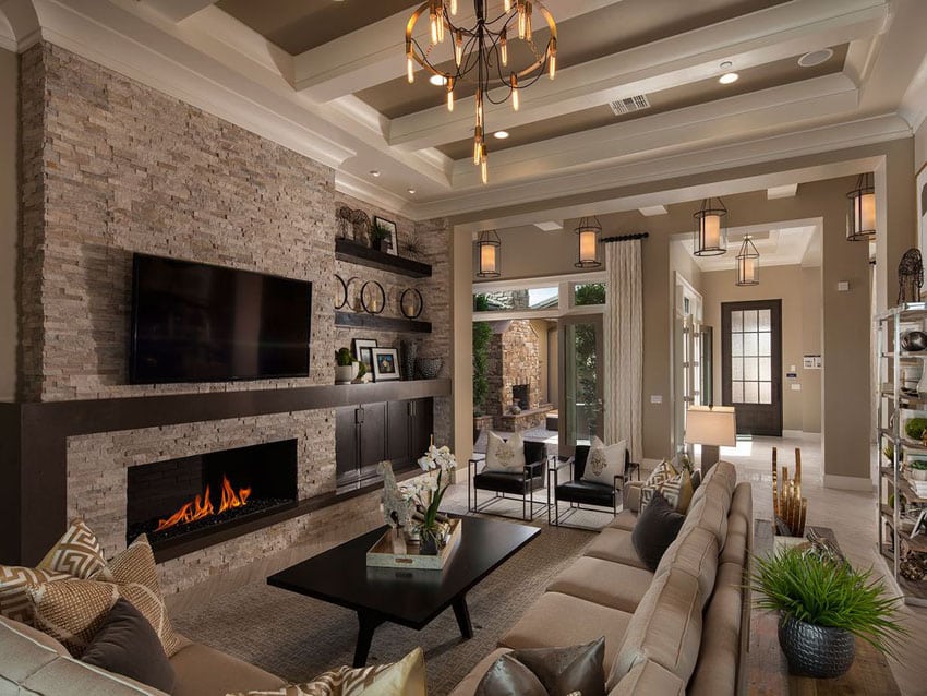 Traditional living room with shades of brown, stone fireplace and high ceilings