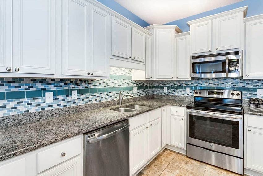 Kitchen with cabinets, blue trimming, ceramic flooring and mosaic wall tiles