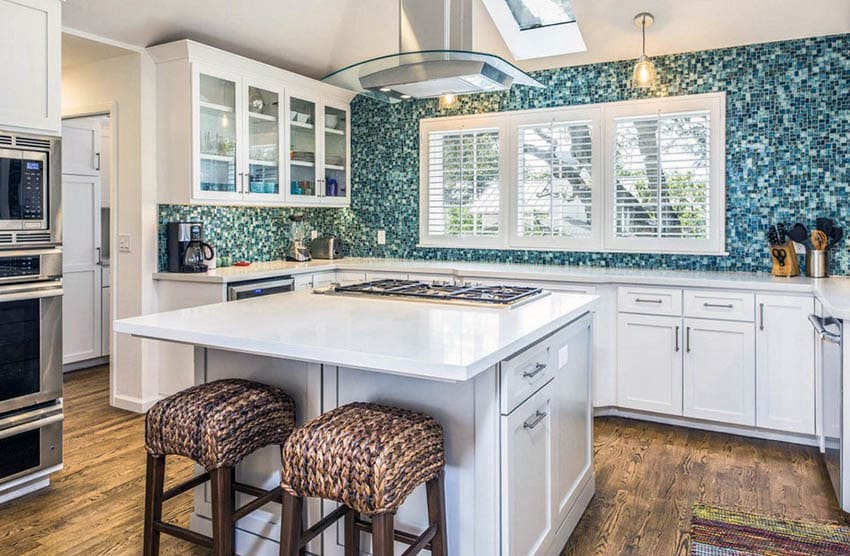 Kitchen with unique blue mosaic wall, stools with fabric upholstery and skylight