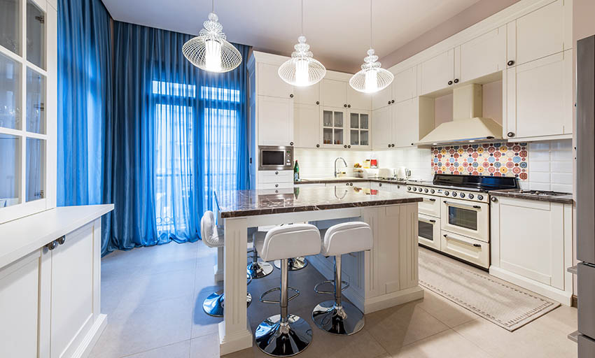 White kitchen with island and cream ceramic floor tiles