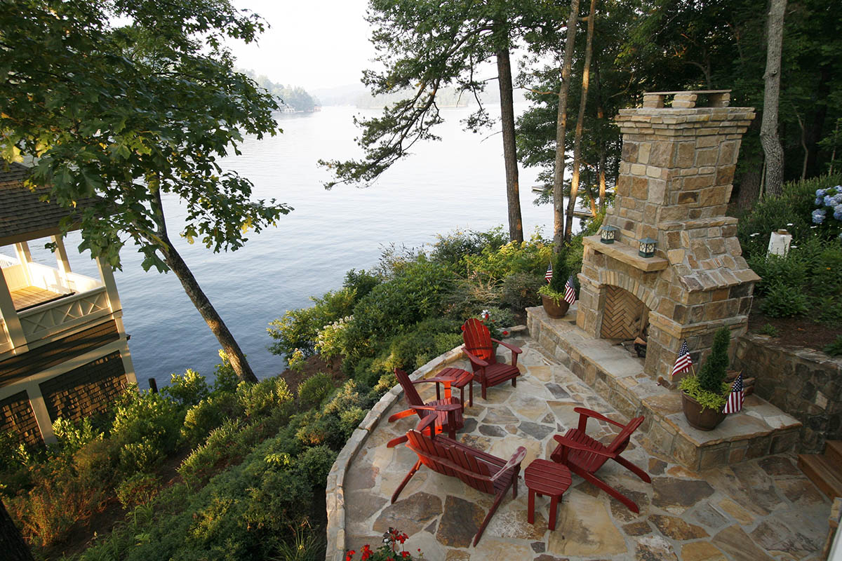 Beautiful outdoor fireplace seating area with lake view