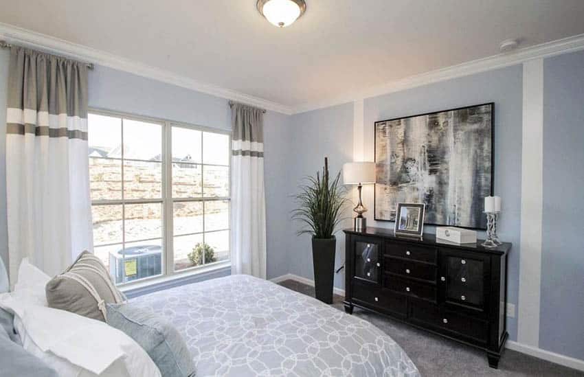 Bedroom with picture windows and pastel blue paint color