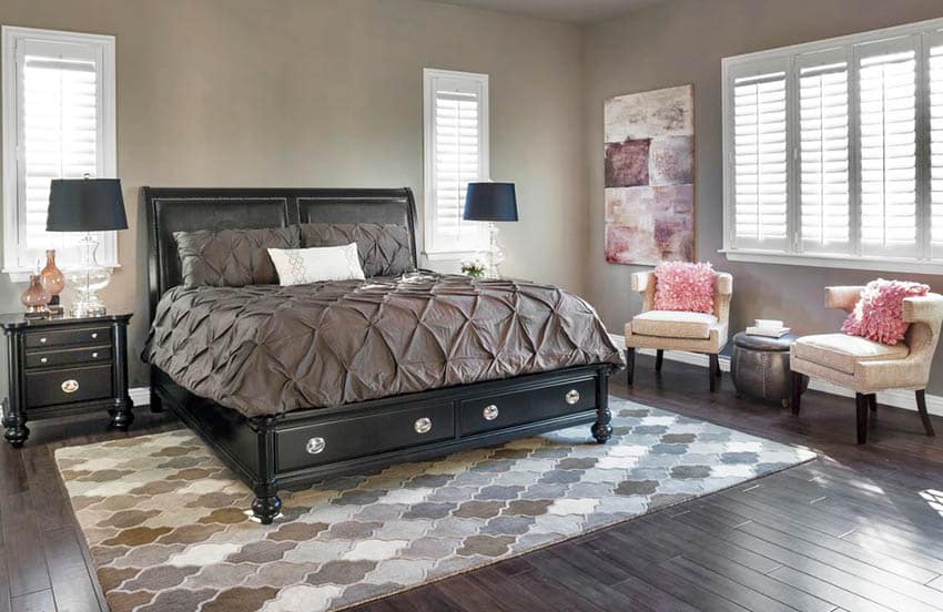 Beige bedroom with corner art and armchairs