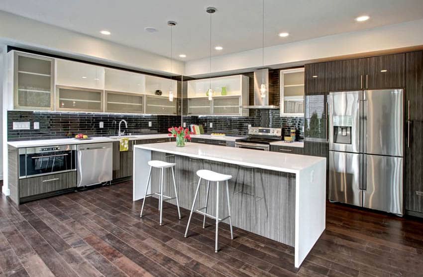 Kitchen with veneer cabinets, glass backsplash and engineered wood floors