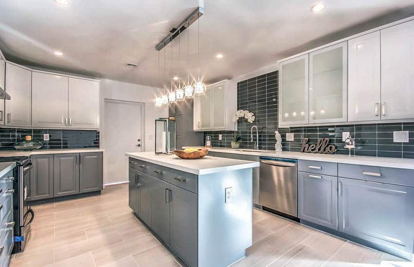 Contemporary kitchen with gray lower cabinets and white upper cabinets with tile backsplash and porcelain tile floors