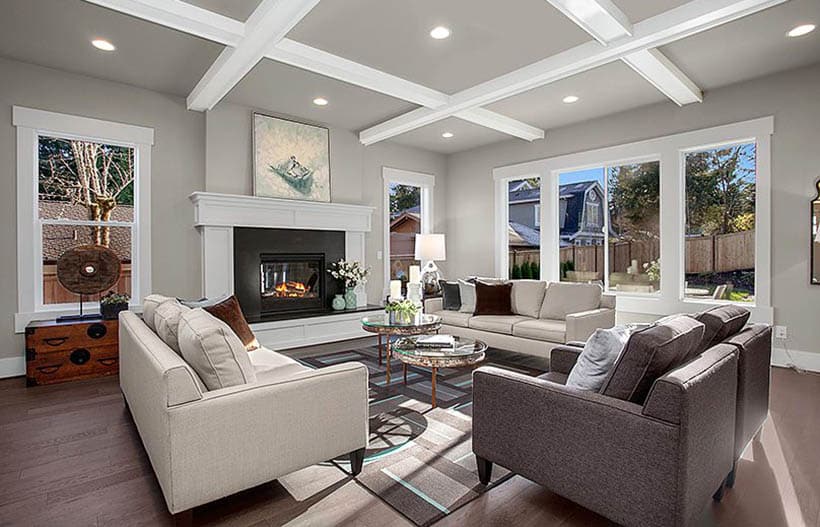 Contemporary living room with gray paint, box ceiling with white trim, and maple wood floors