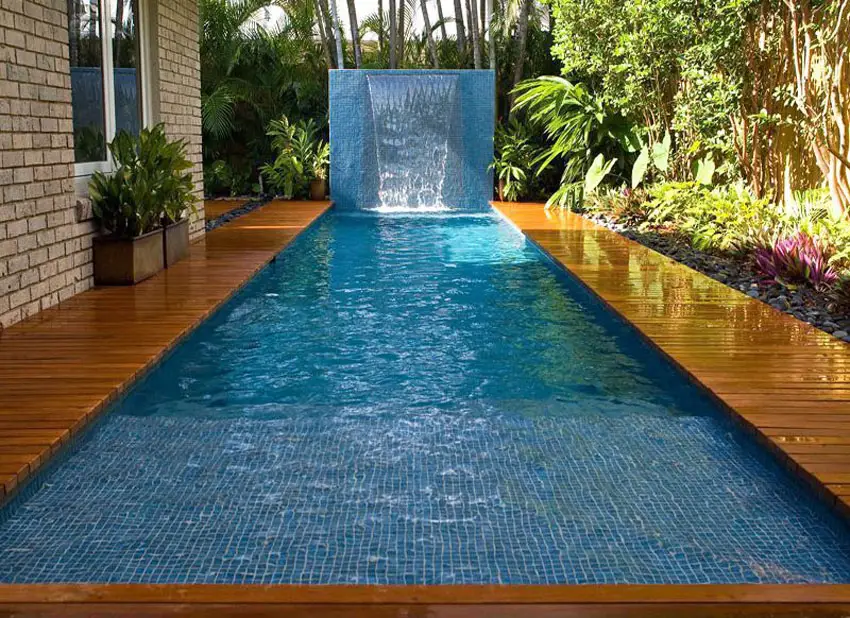 Lap pool with blue mosaic tile wall and cascading water