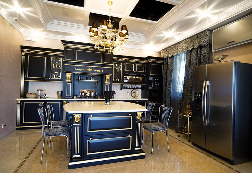 Custom kitchen with navy blue and gold two tone cabinets and cream quartz countertop island