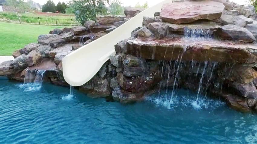 Custom pool with stone waterfall and slide