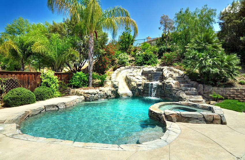 Freeform pool with rock water, slide and elevated tub