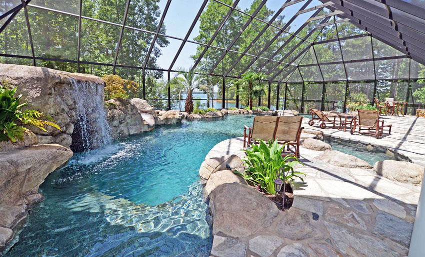 Indoor lagoon swimming pool with stone waterfall
