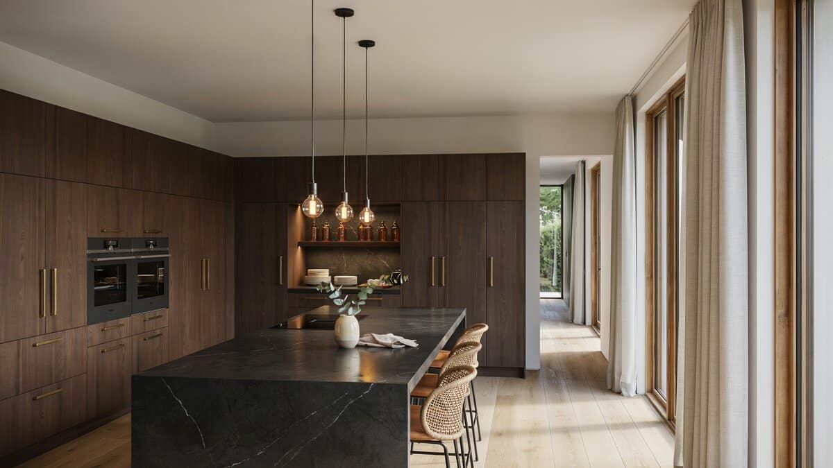 Dark wood cabinets and Edison pendants surround a stone topped dining island