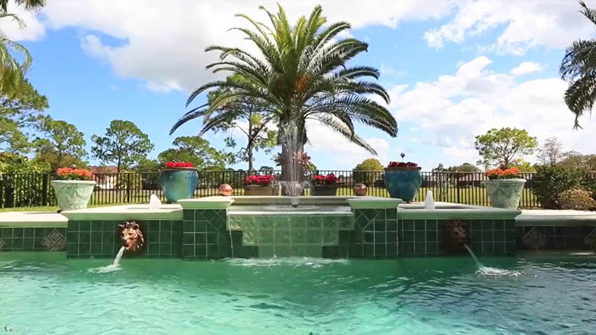 Luxury swimming pool with sheetfall fountain and lion statue waterfalls