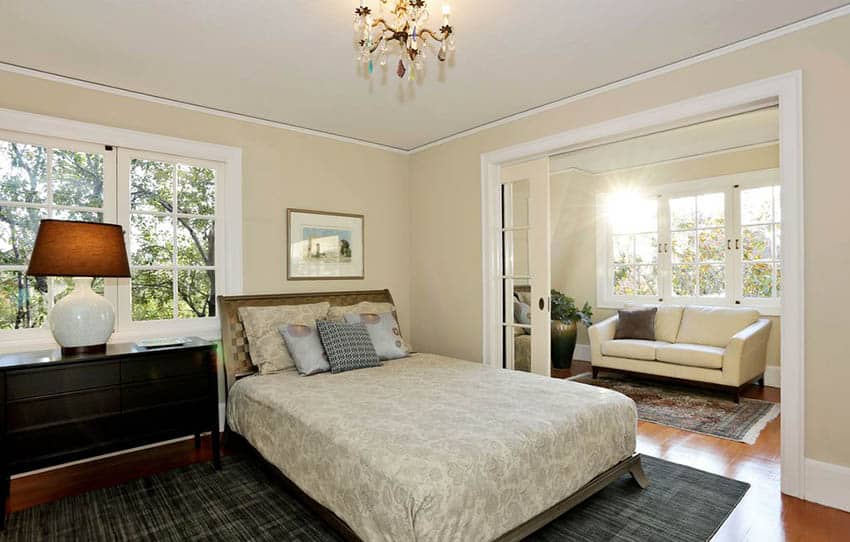 Master bedroom with sliding French pocket doors, chandelier and sitting nook