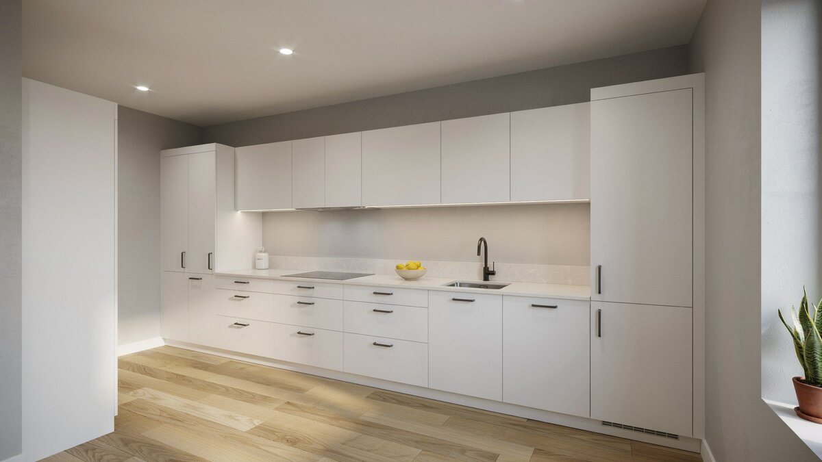 Handleless white cabinetry runs wall to wall against soft gray painted walls