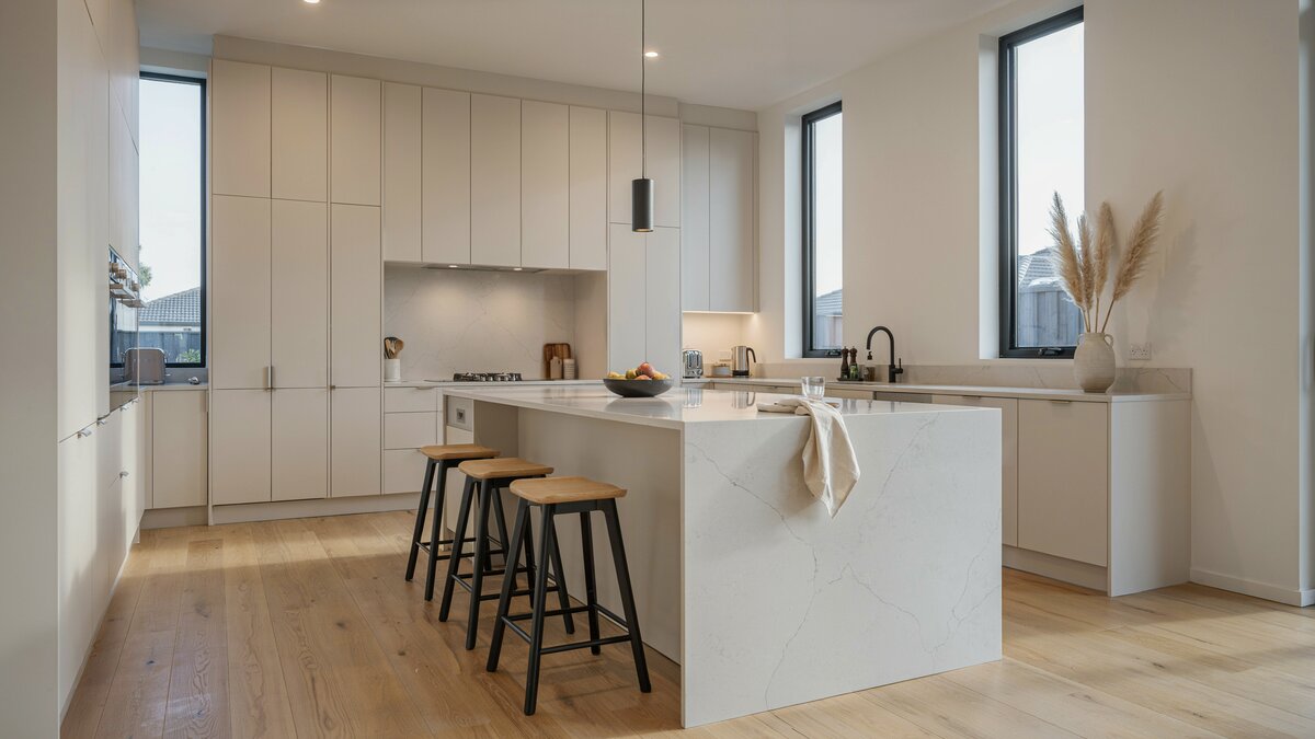 Arctic white quartz island anchors this bright modern kitchen with pale oak flooring