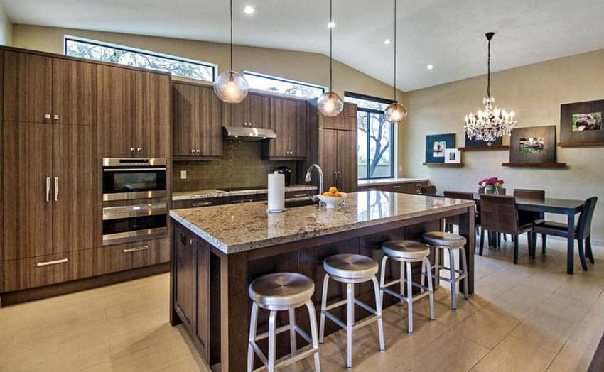 Modern kitchen with vertical dark wood grain cabinets, granite island with seating and open concept design