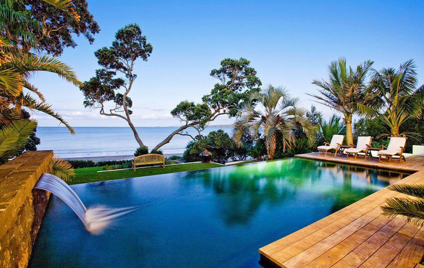 Oceanfront swimming pool with waterfall and wood deck