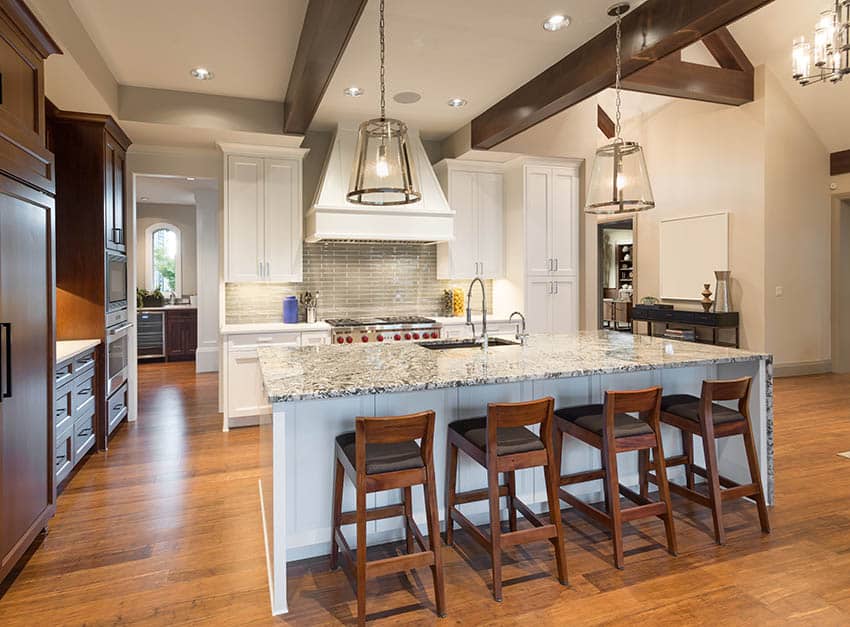 Transitional kitchen with wood finish cabinets and white shaker cabinets with granite counter island