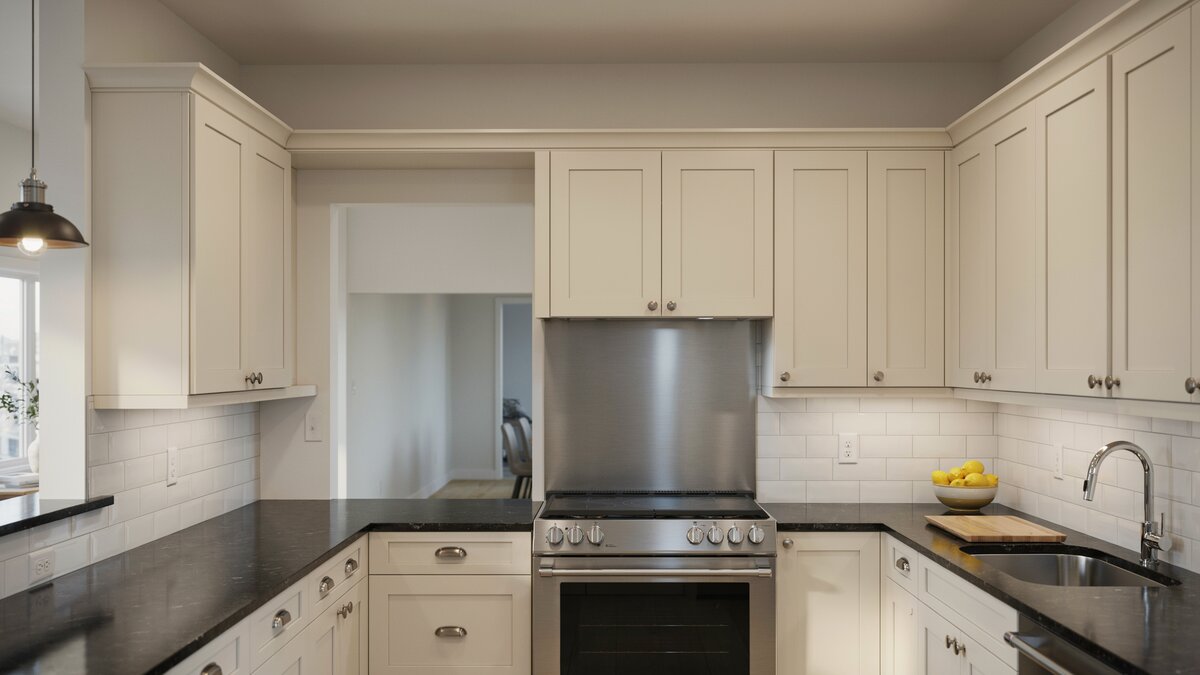 Cream cabinet kitchen with black granite counters and stainless steel backsplash