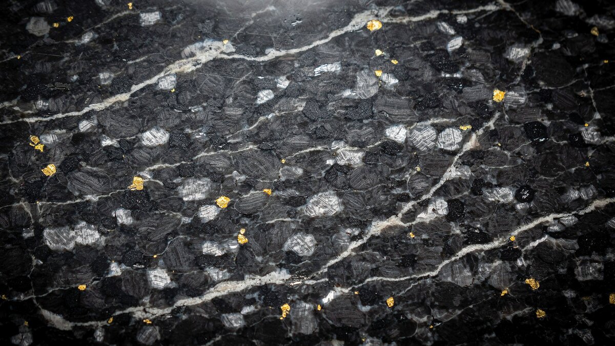 Polished Black Pearl granite slab with shimmering silver and gold mica flecks