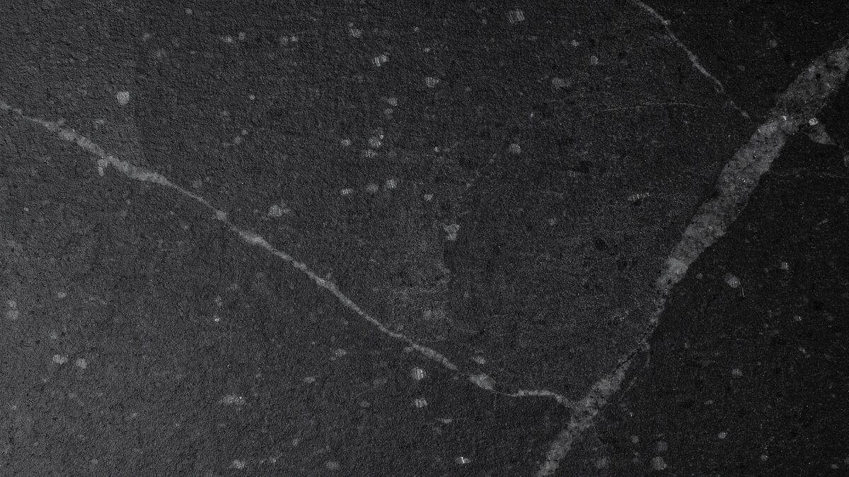 Leathered Cambrian Black granite slab with gray minerals and fine light flecks