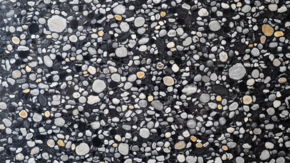Polished Black Marinace granite slab with brown pebbles in a cobblestone pattern