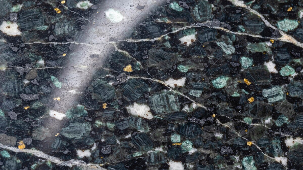 Polished Black Uba Tuba granite slab with green black surface and gold speckles