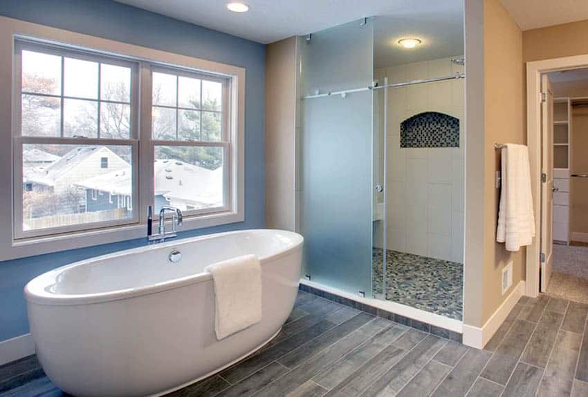 Bathroom with sliding shower door mosaic tile and freestanding tub