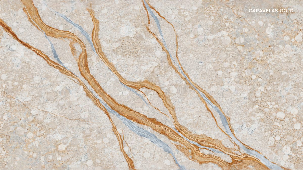Beige stone with sweeping amber swirls and thin pale blue mineral lines