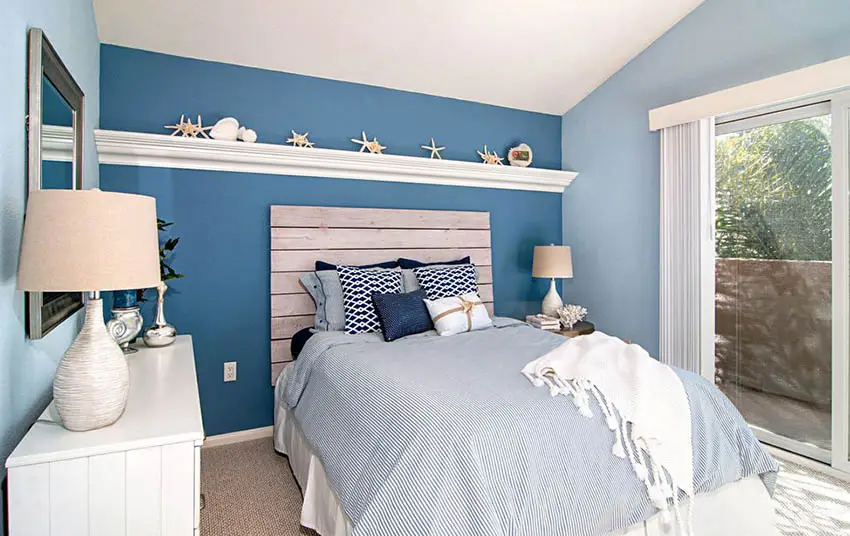 Coastal style bedroom with wood plank headboard