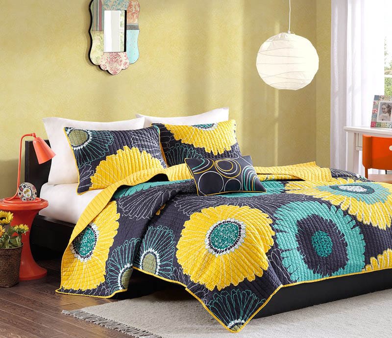 Colorful teen girls bedroom with floral pillows and comforter