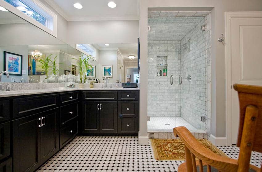 Bathroom with hinged doors, dark vanity and penny tiles