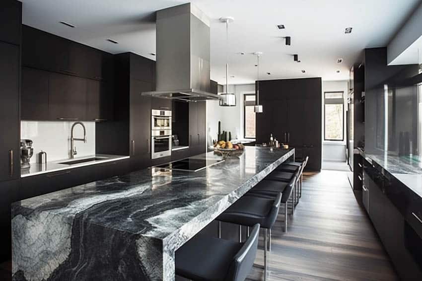 Contemporary kitchen with granite waterfall counter and white glass backsplash