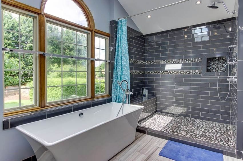 Bathroom with glass tile shower walls and arched windows
