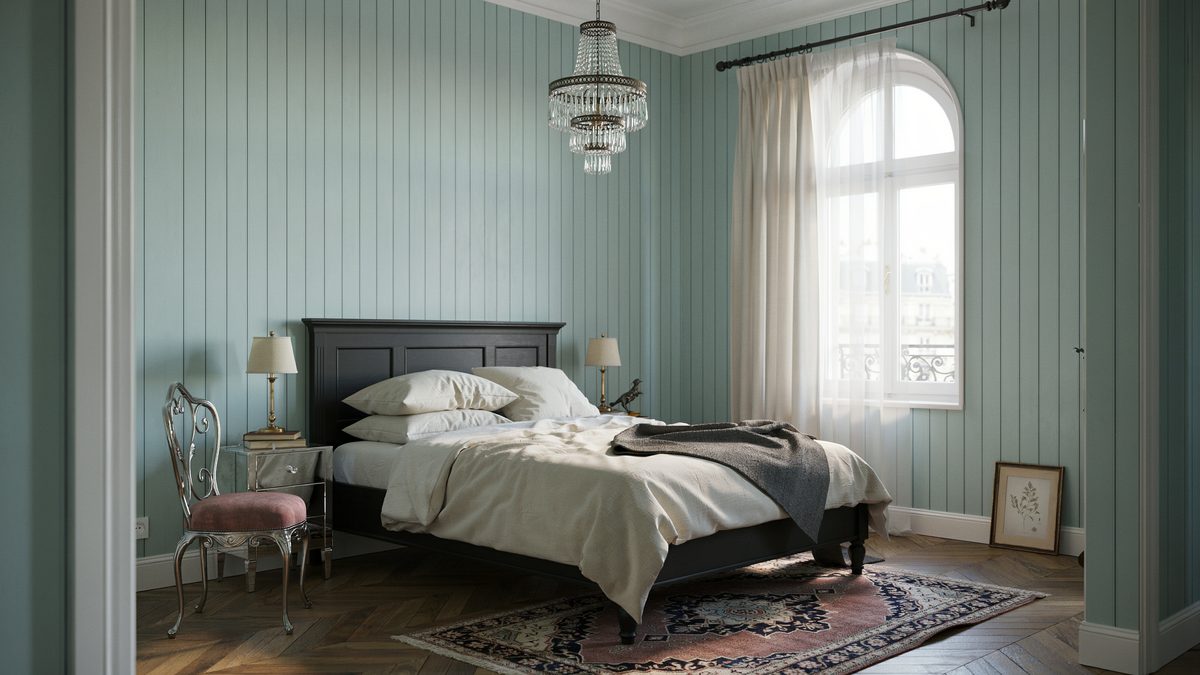 Sage green paneled bedroom with black wood bed and tall arched window