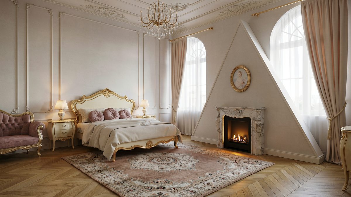 Gilded rococo bed and crystal chandelier facing a small marble corner firebox